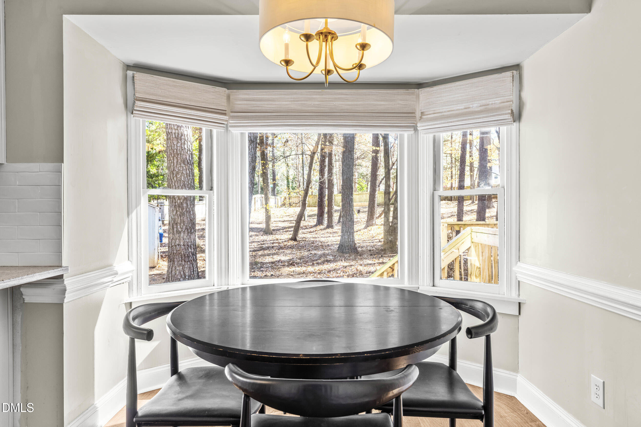 10716 Marthas Way Raleigh, NC 27615 - Photo 10 of 32 a view of a dining room with furniture wooden floor and chandelier