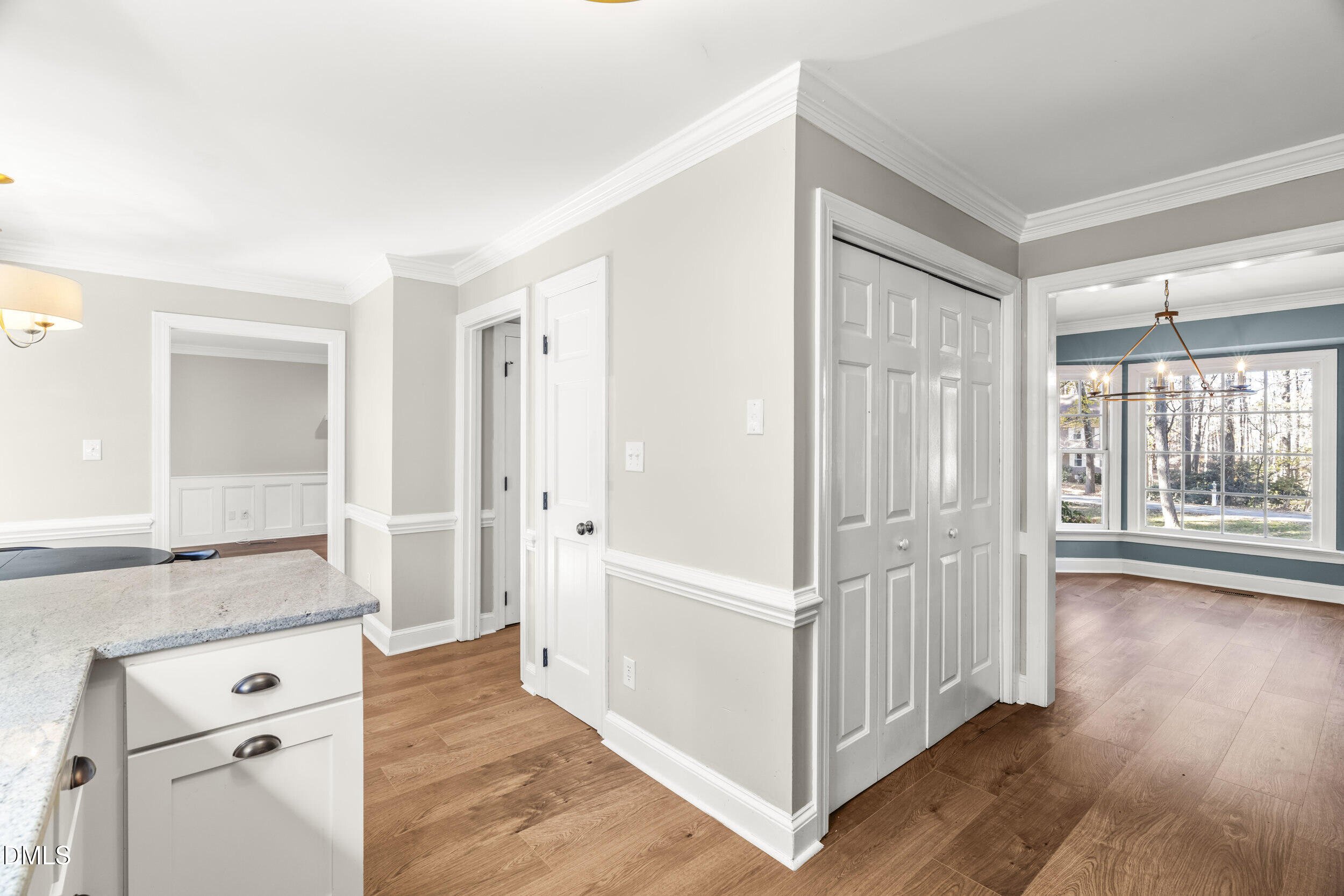 10716 Marthas Way Raleigh, NC 27615 - Photo 13 of 32 a view of a hallway with wooden floor and cabinet
