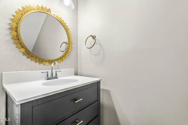 a view of a hallway with wooden floor and cabinet