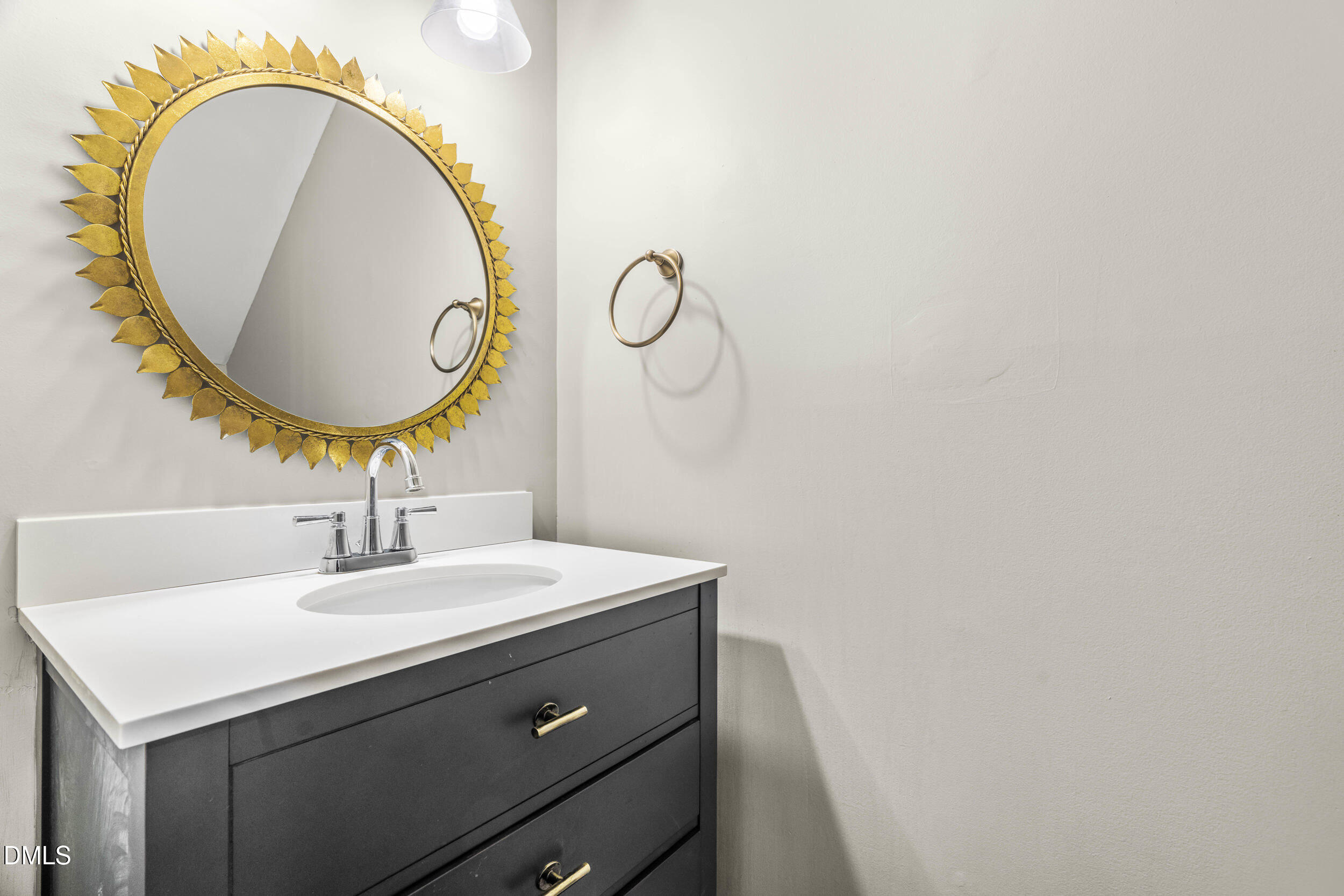 10716 Marthas Way Raleigh, NC 27615 - Photo 14 of 32 a bathroom with a sink and a mirror
