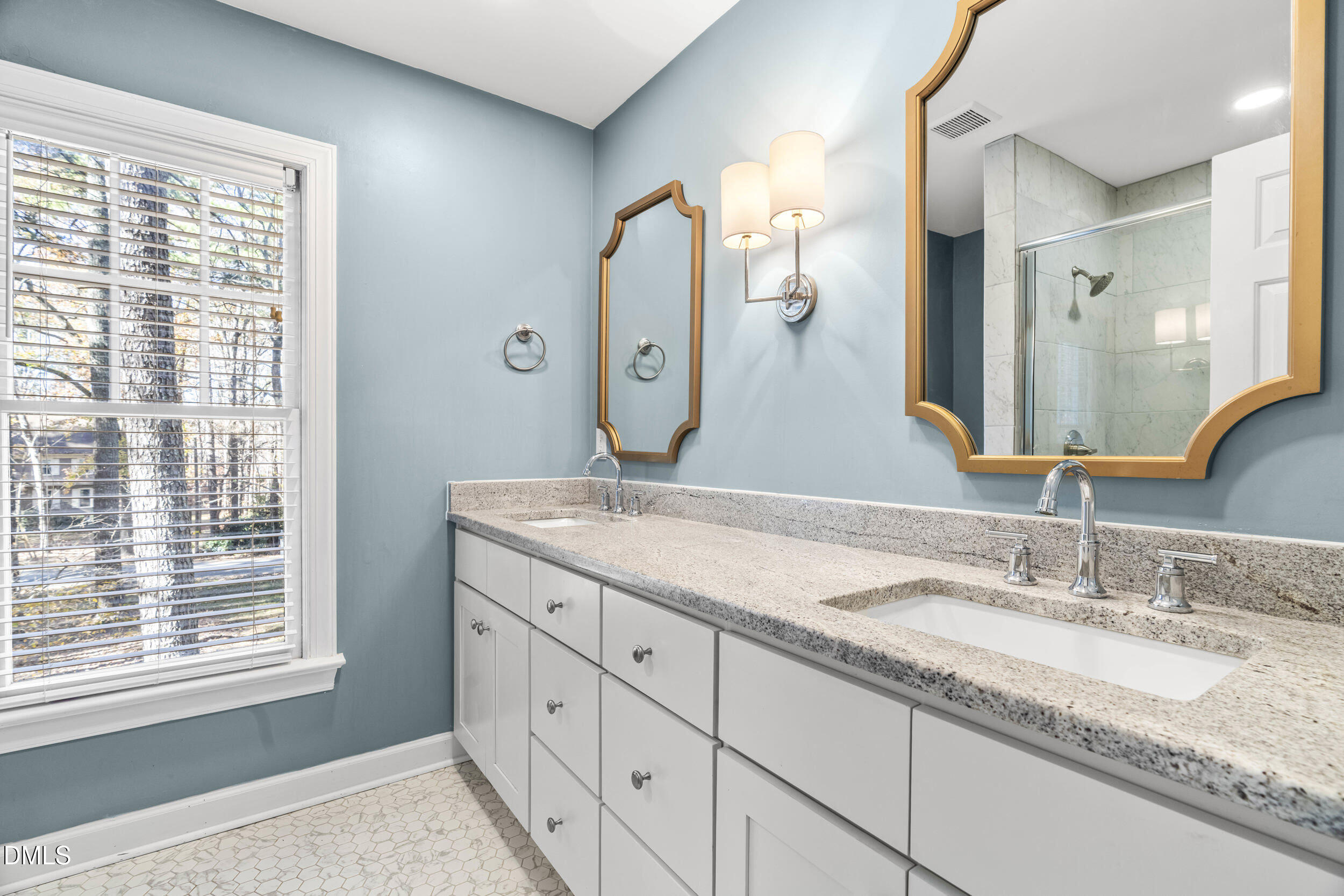 10716 Marthas Way Raleigh, NC 27615 - Photo 18 of 32 a bathroom with a granite countertop double vanity and a mirror