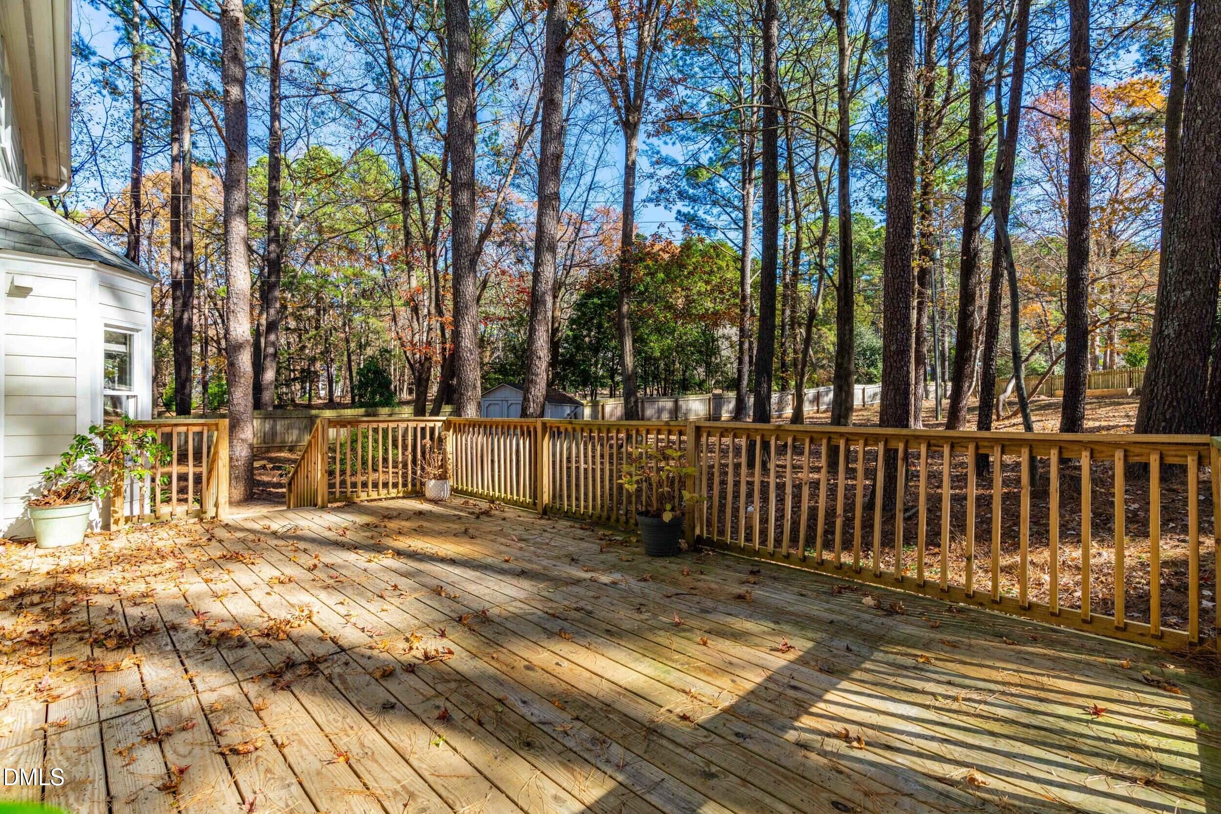 10716 Marthas Way Raleigh, NC 27615 - Photo 26 of 32 a view of a brick house with large windows and trees