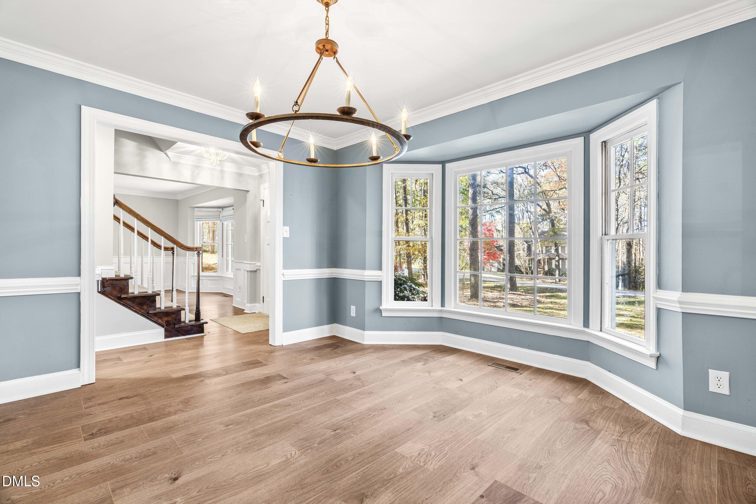 10716 Marthas Way Raleigh, NC 27615 - Photo 6 of 32 a view of an empty room with wooden floor and a window