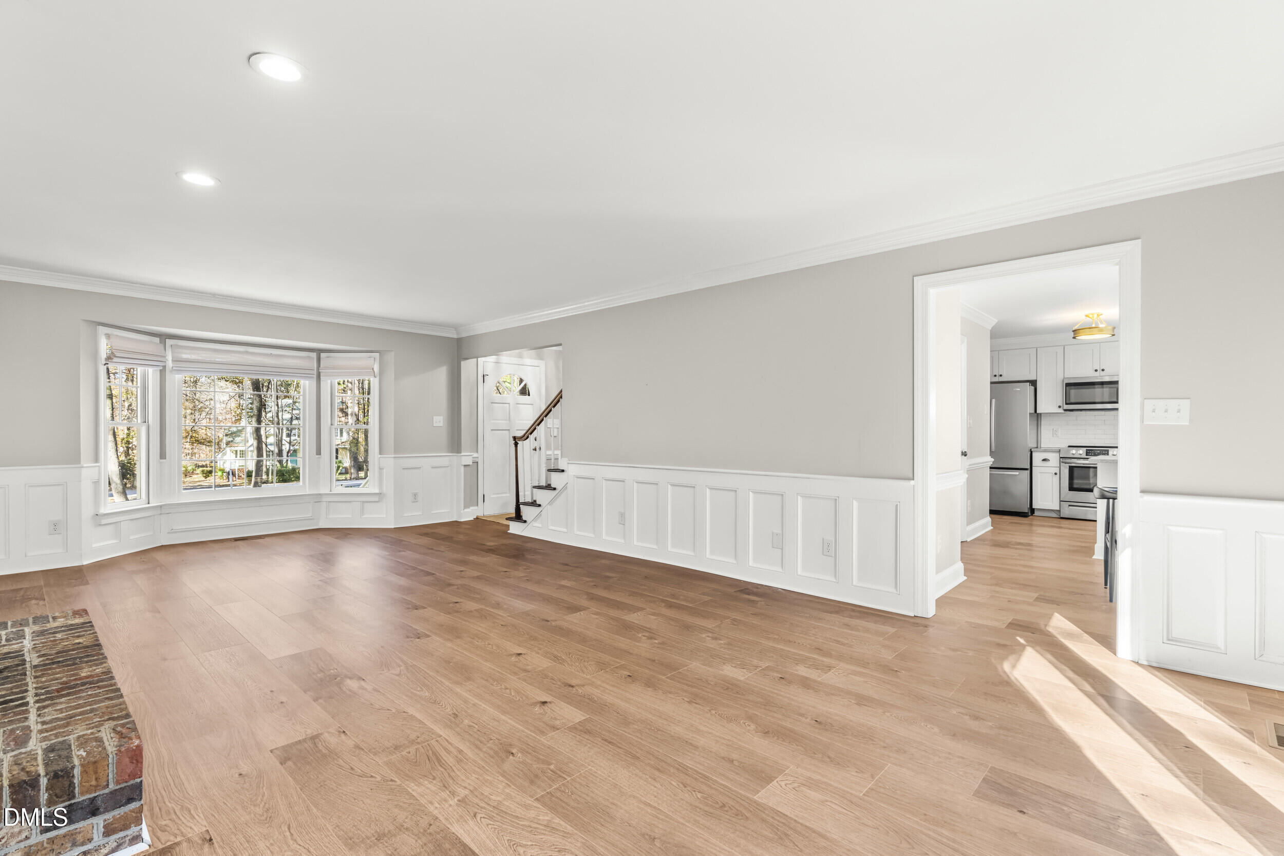10716 Marthas Way Raleigh, NC 27615 - Photo 8 of 32 an empty room with windows and fireplace