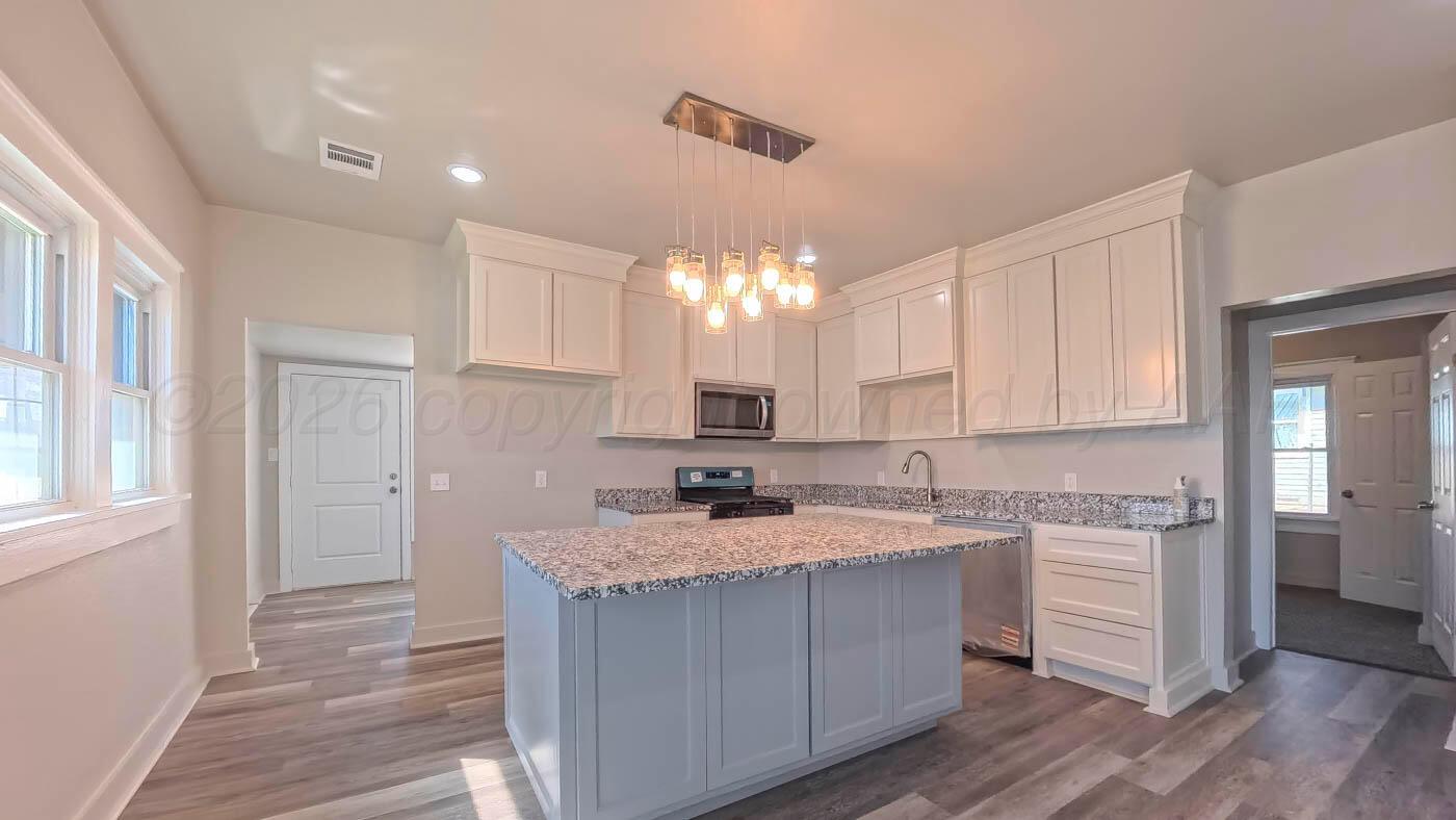 1316 Withers Avenue Amarillo, TX 79108 - Photo 12 of 19 a kitchen with a sink stove and cabinets