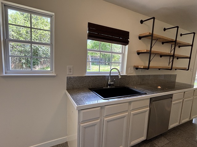 6303 Brookside Drive Austin, TX 78723 - Photo 12 of 26 a kitchen with a sink and cabinets