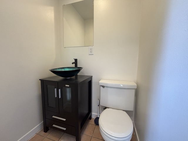 6303 Brookside Drive Austin, TX 78723 - Photo 13 of 26 a bathroom with a toilet a sink and a mirror