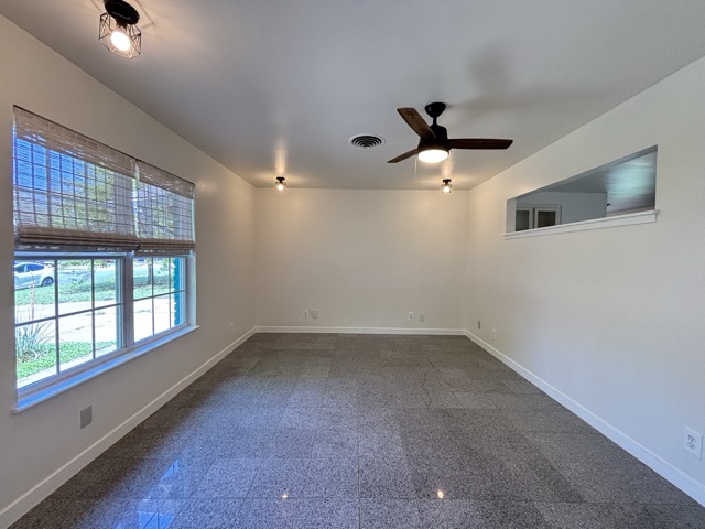 6303 Brookside Drive Austin, TX 78723 - Photo 15 of 26 an empty room with windows and ceiling fan