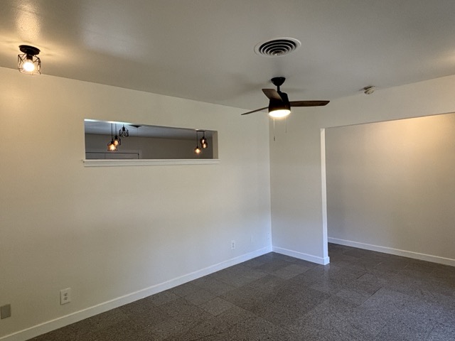 6303 Brookside Drive Austin, TX 78723 - Photo 17 of 26 an empty room with a ceiling fan and carpet