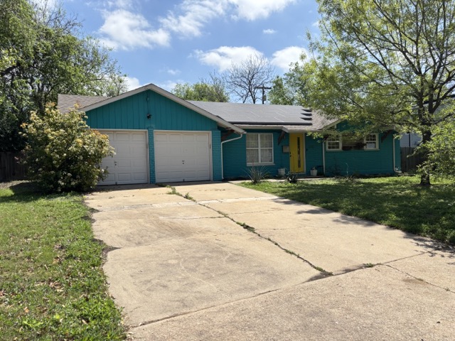 6303 Brookside Drive Austin, TX 78723 - Photo 2 of 26 a front view of a house with a yard and trees
