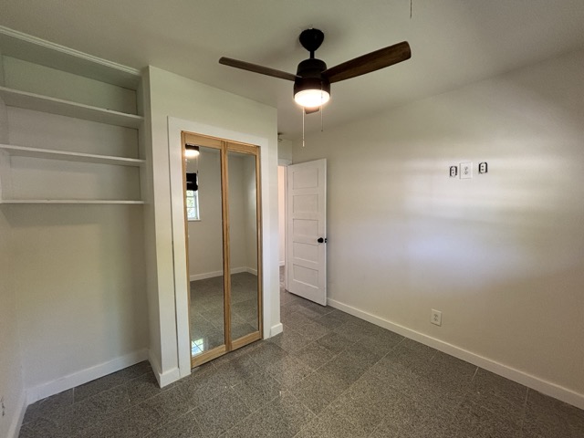 6303 Brookside Drive Austin, TX 78723 - Photo 23 of 26 an empty room with closet and a chandelier fan