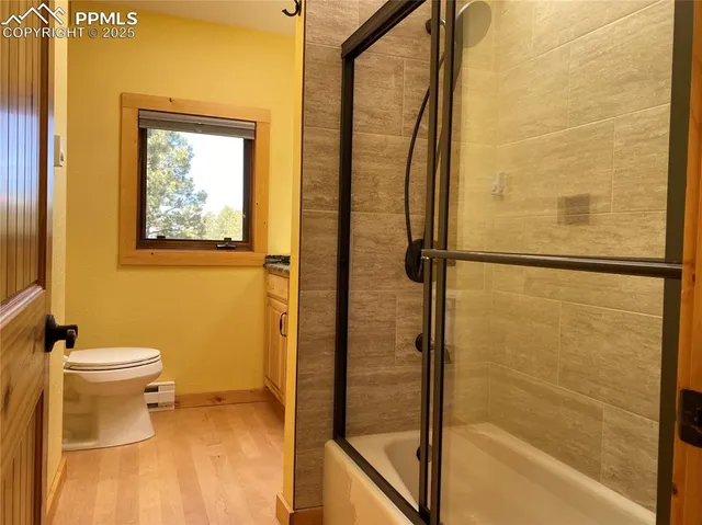 a bathroom with a toilet and a shower