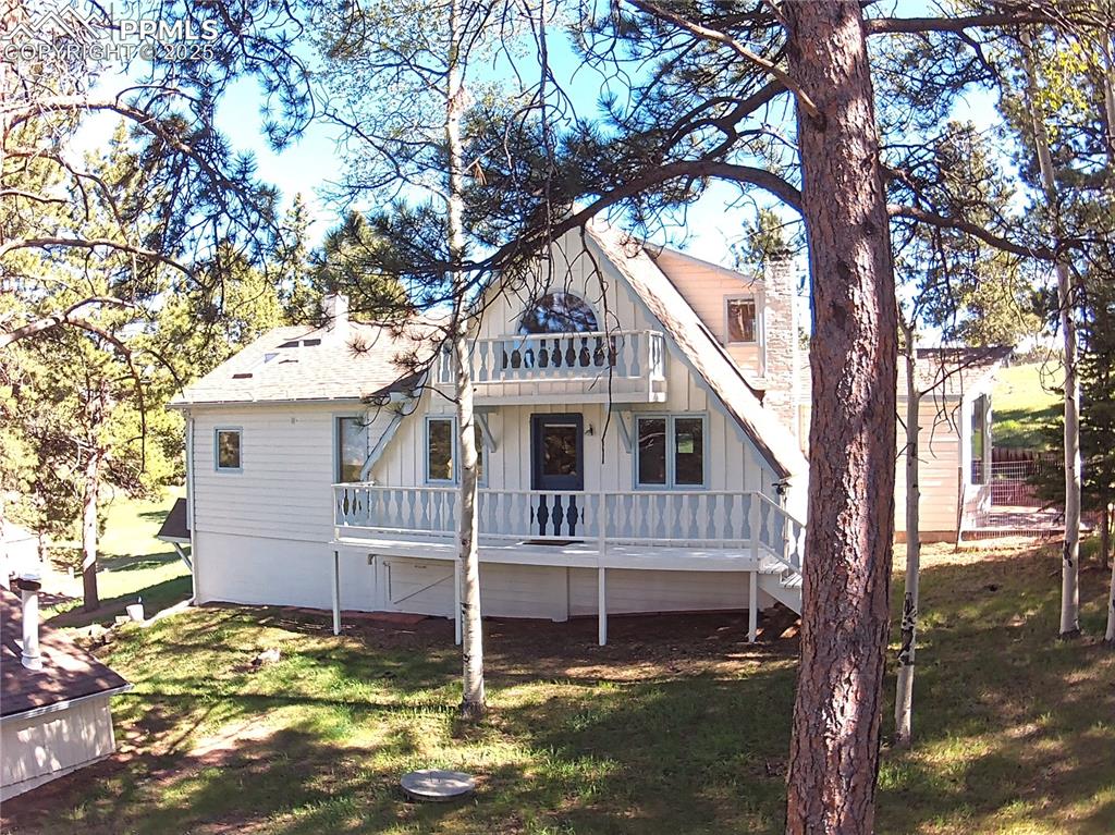 845 Markus Road Woodland Park, CO 80863 - Photo 2 of 40 a house with trees in front of it