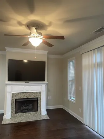a living room with a fireplace and a flat screen tv