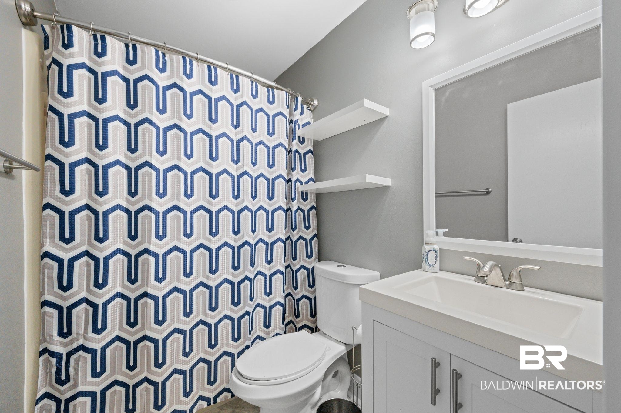 1107 North Oak Street Loxley, AL 36551 - Photo 20 of 40 Bathroom with vanity, toilet, and curtained shower