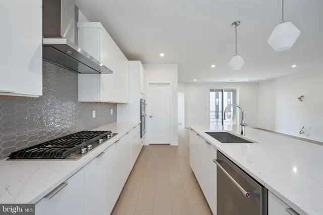 a kitchen with kitchen island granite countertop a sink and stove