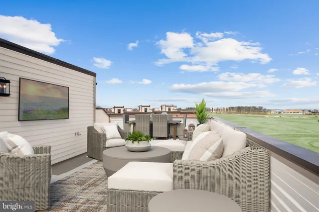a view of a terrace with furniture and city view