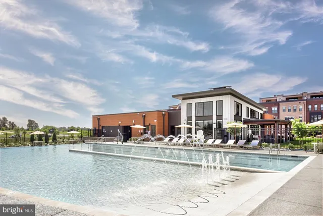 a view of building with river and trees in the background