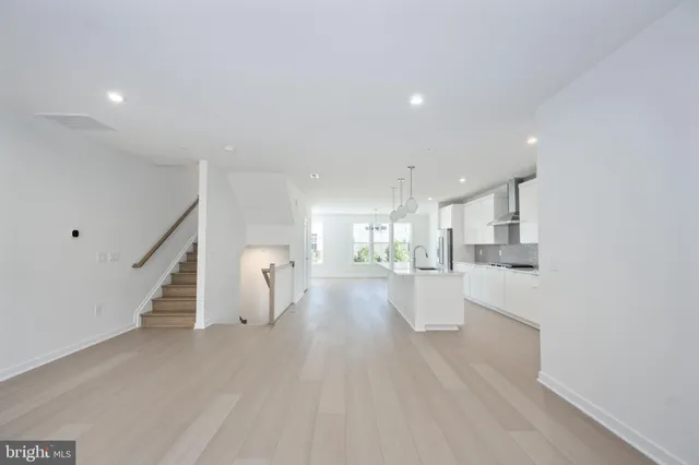 a view of a living room with furniture and wooden floor