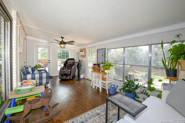 a living room filled with furniture and a large window