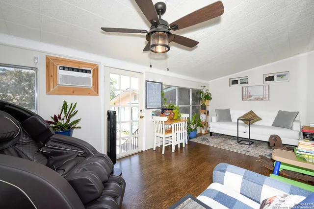 a living room with furniture and wooden floor