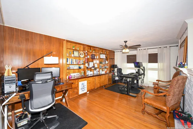 a room with lots of chairs and wooden floor