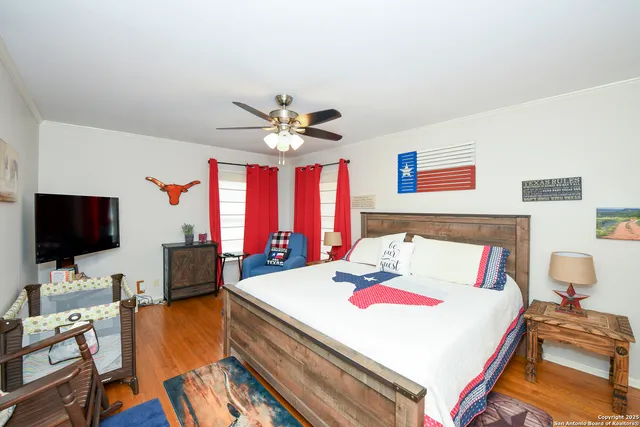 a bedroom with a bed and a flat screen tv