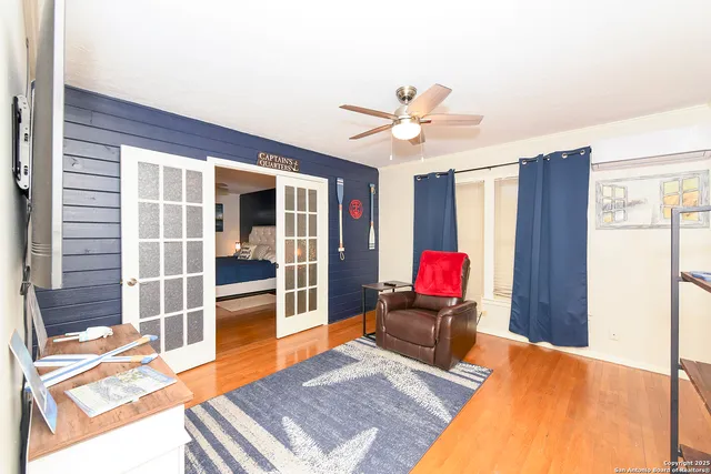 a living room with furniture a rug and white walls