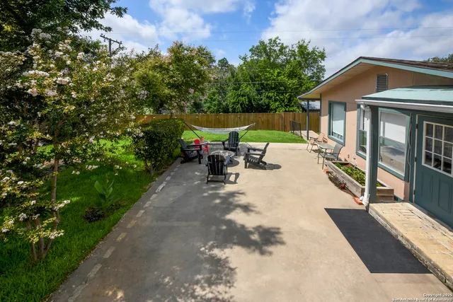 a view of a patio with a table and chairs under an umbrella