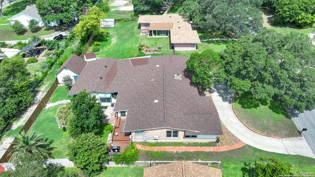 an aerial view of house with a swimming pool outdoor seating and yard