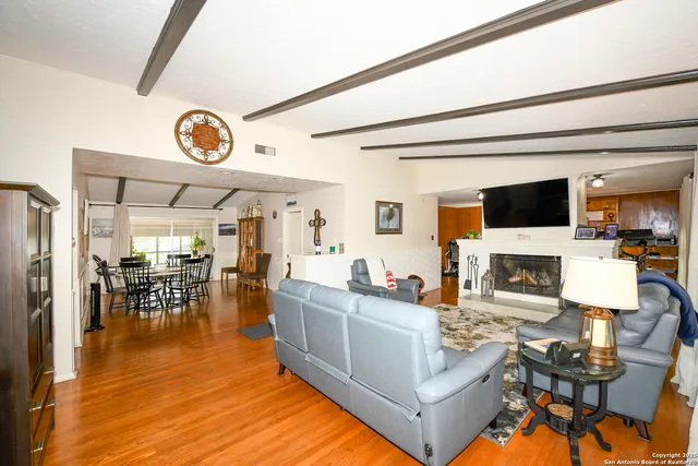 a living room with fireplace furniture and a flat screen tv