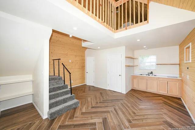 a view of kitchen with wooden floor and electronic appliances