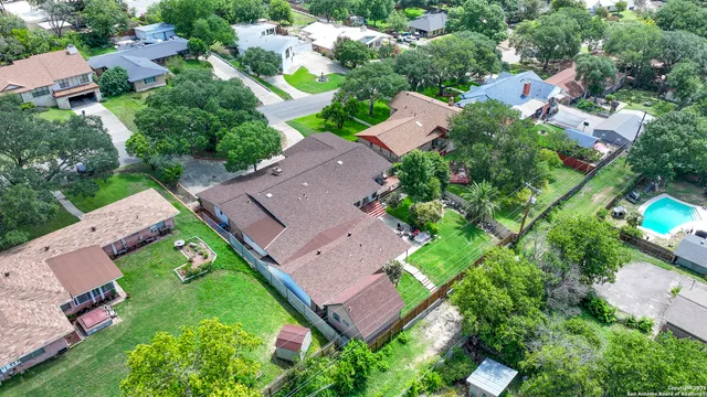 an aerial view of residential houses with outdoor space