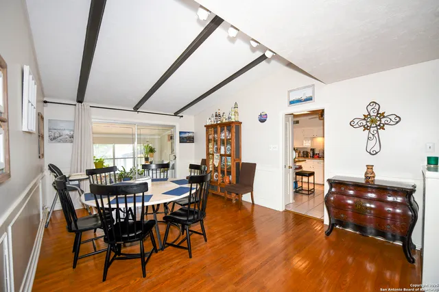 a view of a dining room with furniture and wooden floor
