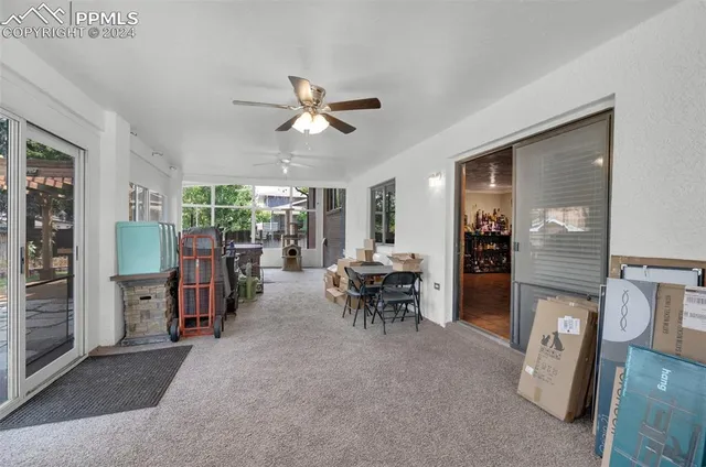 a view of a livingroom with furniture and a window