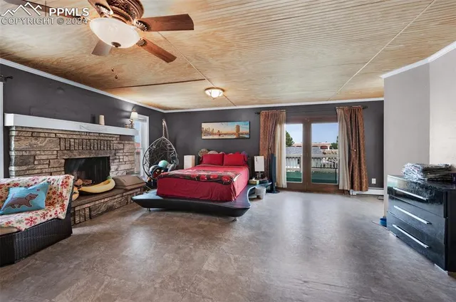 a spacious bedroom with a bed and a fireplace