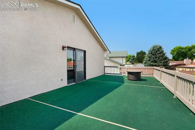 a backyard of a house with table and chairs