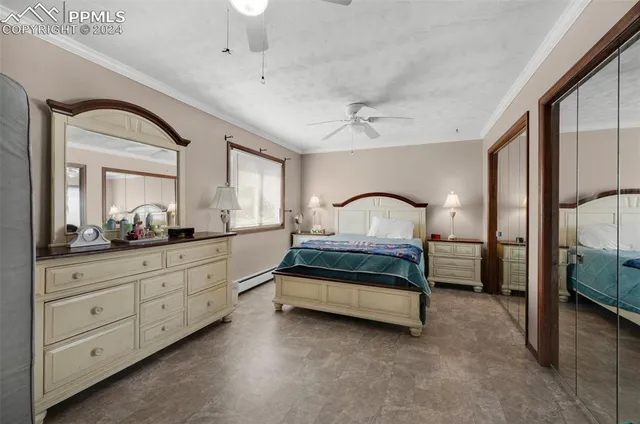 a spacious bedroom with a bed and a large window with the outer view