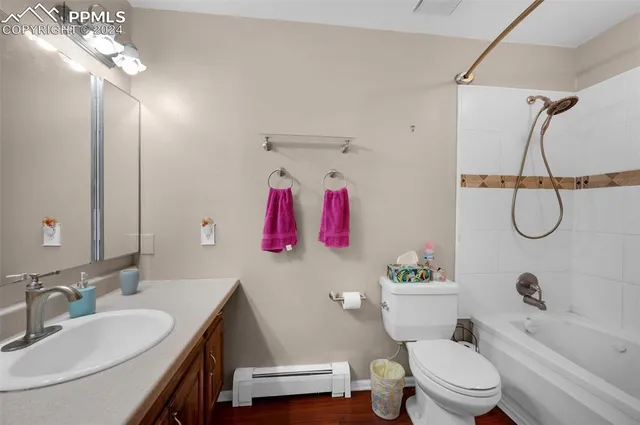 a bathroom with a sink vanity mirror and toilet