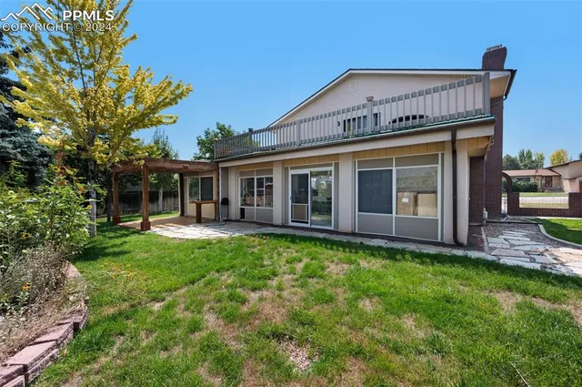 a view of a house with a yard and porch