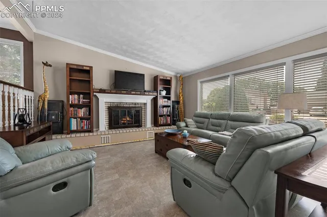 a living room with furniture flat screen tv and a fireplace