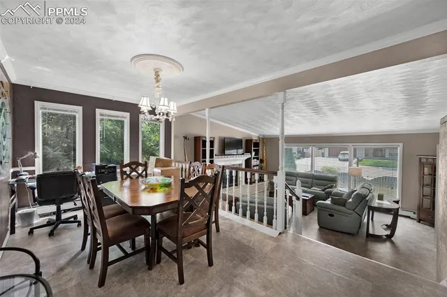 a view of a dining room with furniture and chandelier