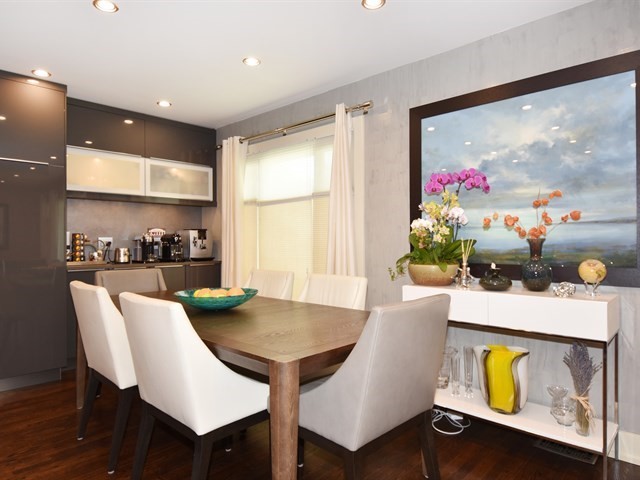 7715 East Prairie Road Skokie, IL 60076 - Photo 11 of 26 a view of a dining room with furniture and a potted plant