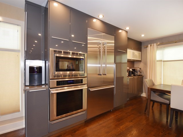 7715 East Prairie Road Skokie, IL 60076 - Photo 12 of 26 a kitchen with cabinets and stainless steel appliances