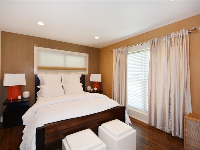 7715 East Prairie Road Skokie, IL 60076 - Photo 15 of 26 a bedroom with a bed and a window