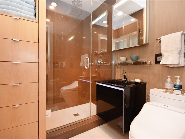 7715 East Prairie Road Skokie, IL 60076 - Photo 16 of 26 a bathroom with a sink a toilet and shower