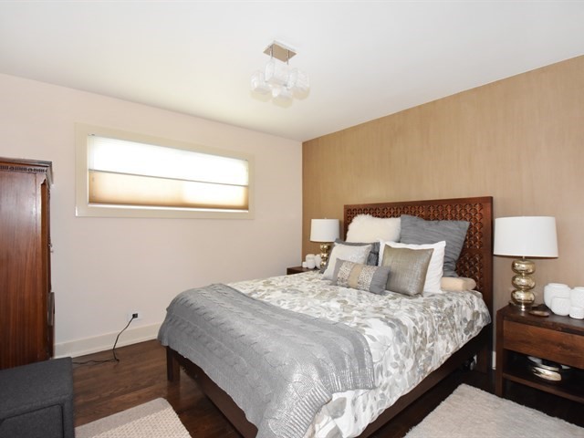 7715 East Prairie Road Skokie, IL 60076 - Photo 17 of 26 a bedroom with a bed and a lamp