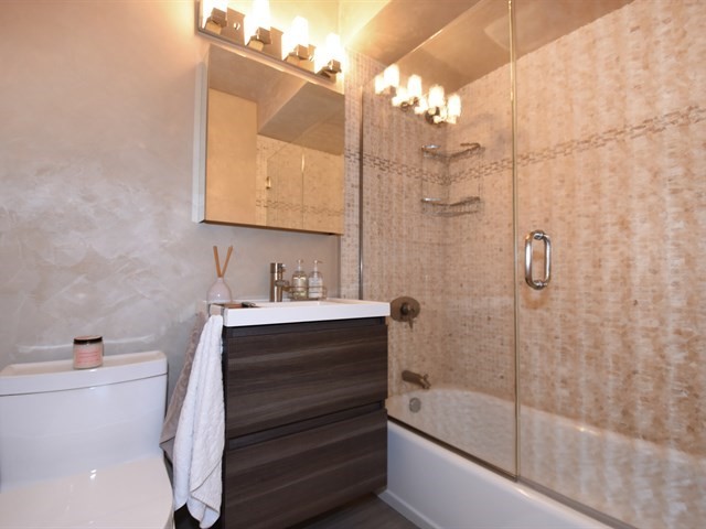 7715 East Prairie Road Skokie, IL 60076 - Photo 20 of 26 a bathroom with a sink a toilet and shower