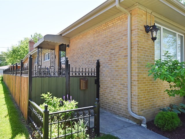 7715 East Prairie Road Skokie, IL 60076 - Photo 3 of 26 a front view of a house with a garden