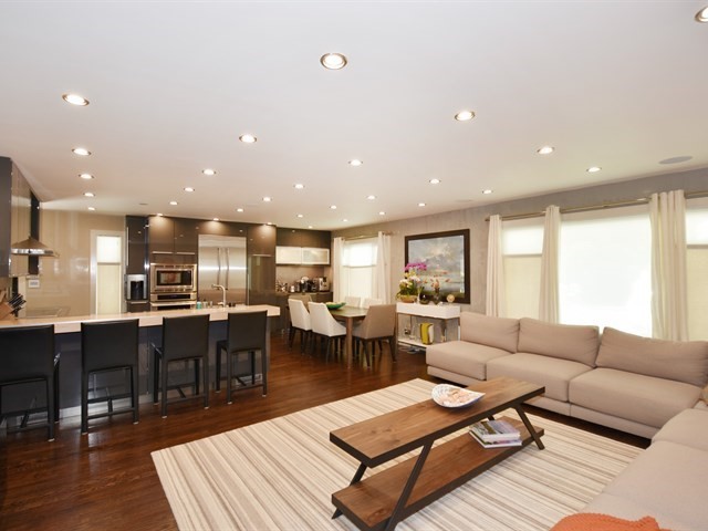 7715 East Prairie Road Skokie, IL 60076 - Photo 5 of 26 a living room with furniture a wooden floor and kitchen view